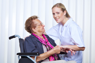 nurse and an old woman in a wheelchair